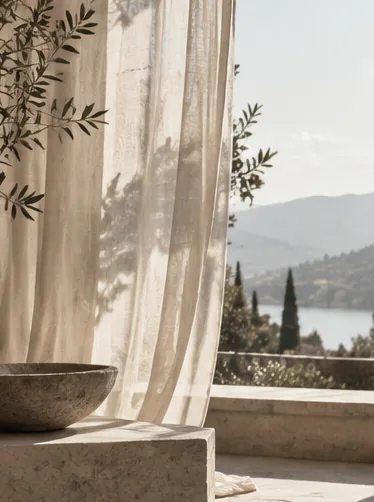 Sunlit linen curtains overlooking a quiet European lake